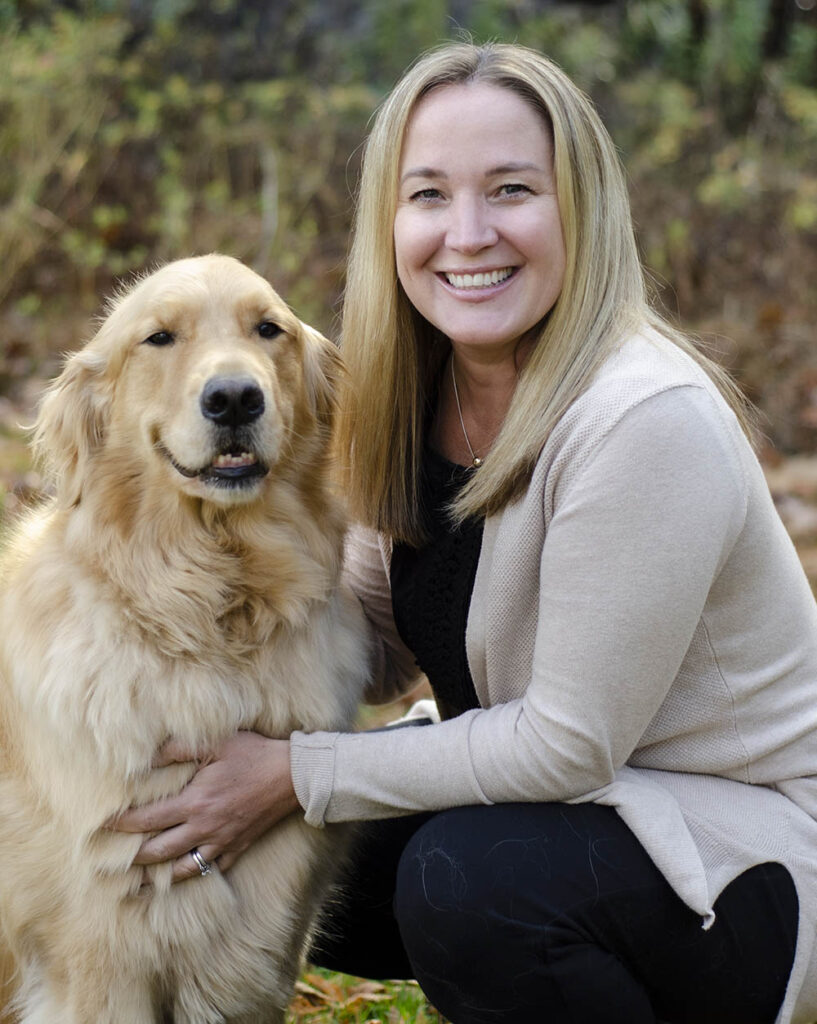 Hilary Hayner, co-owner of Seacoast Hand Therapy, with Finn, a Golden Retriever.