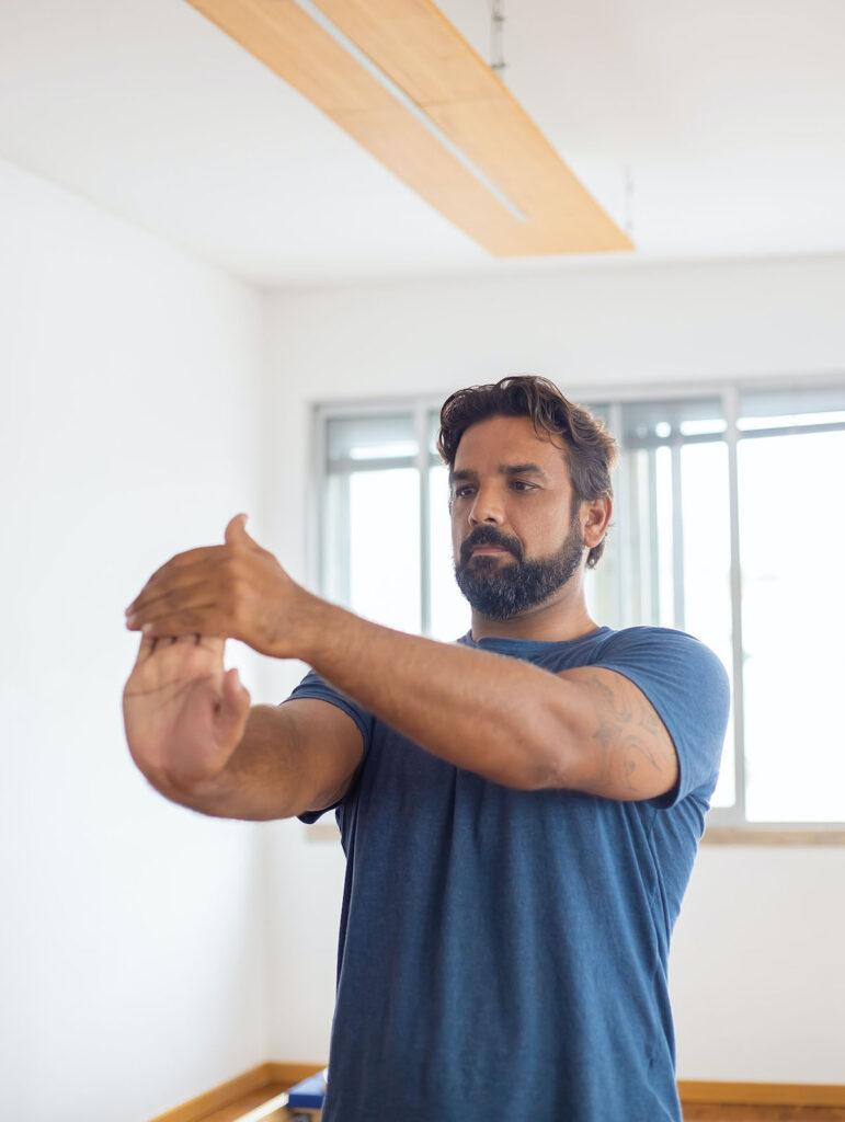 A person participating in physical therapy exercises to strengthen their wrist and upper extremities.